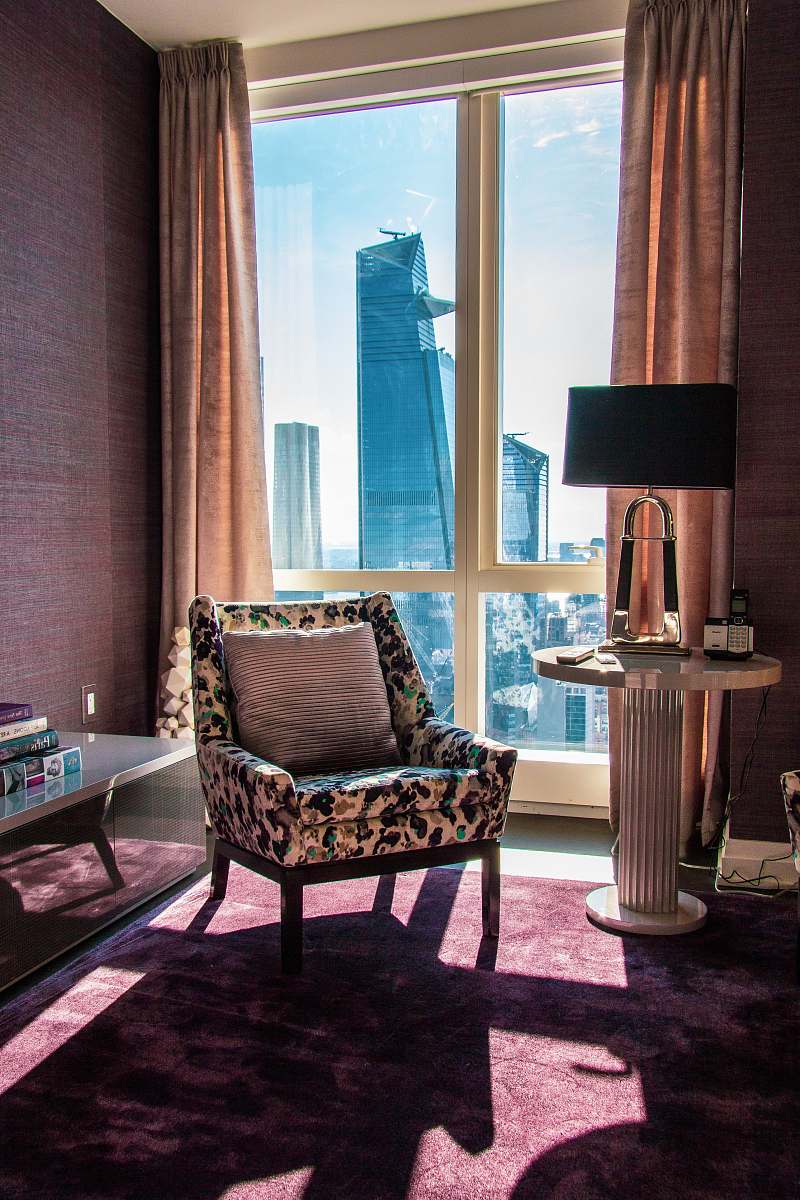 indoors black and brown sofa chair near glass window furniture